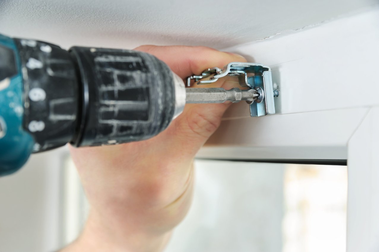 Installing wooden blinds.